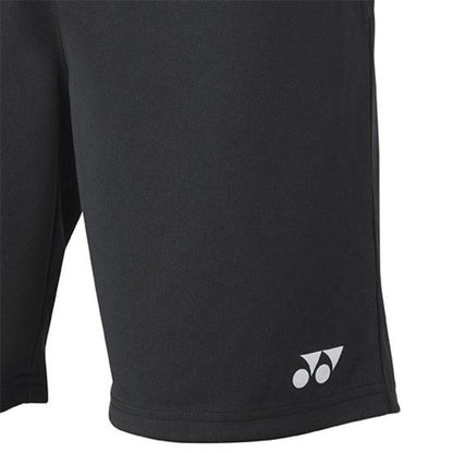 A close-up of the Yonex YS4000EX Black Junior Badminton Shorts showcases a small white logo on the lower right side. The smooth polyester fabric highlights the minimalistic design and efficiently absorbs sweat, ensuring comfort during play.