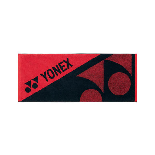 The Yonex AC1108EX Badminton Sports Towel in Red Black, crafted from 100% cotton, features a diagonal design. The towel includes a red top left section showcasing the "Yonex" logo in black, while the bottom right section is black with two prominent red Yonex logos.